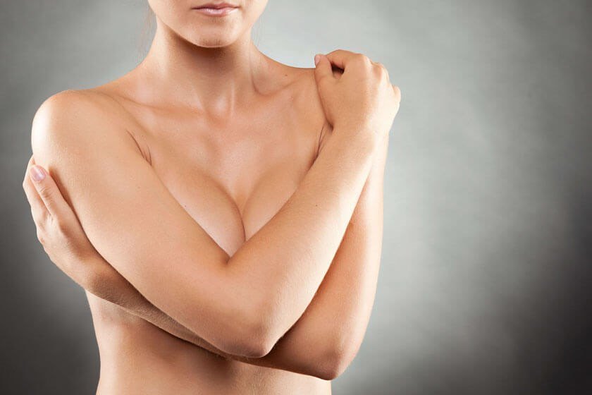 Woman covering her breasts - Breast Augmentation in The Woodlands, TX