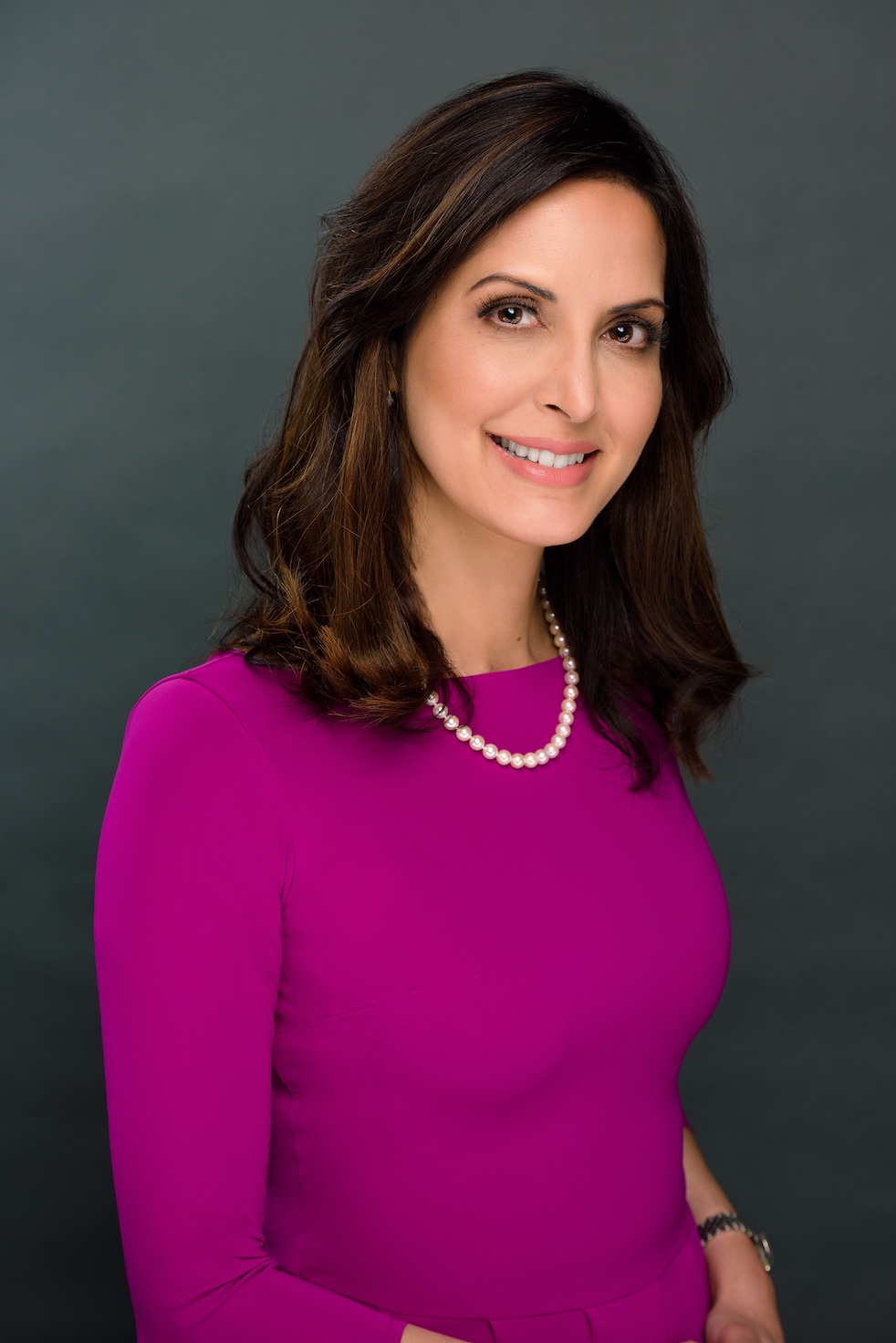Dr. Anita Gill in Bright Pink Dress - Dermatologist in The Woodlands, TX