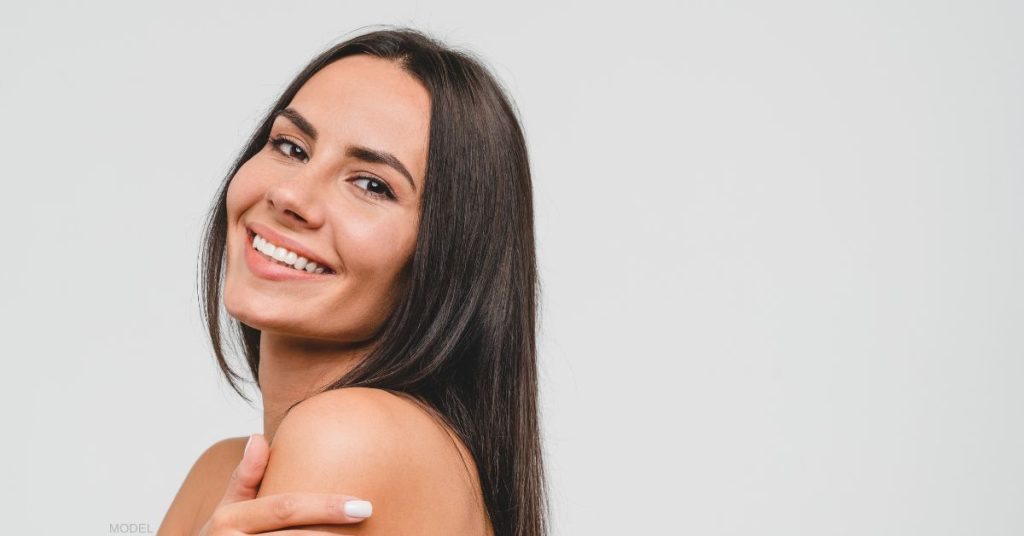 Brunette woman with beautiful skin smiling (model)