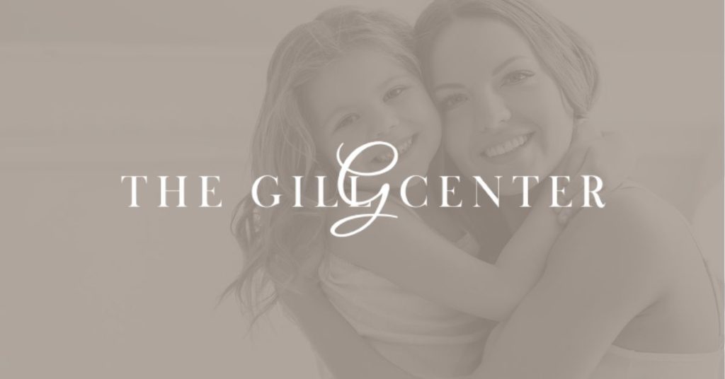 The Gill Center logo over an image of a woman considering mommy makeover and her daughter